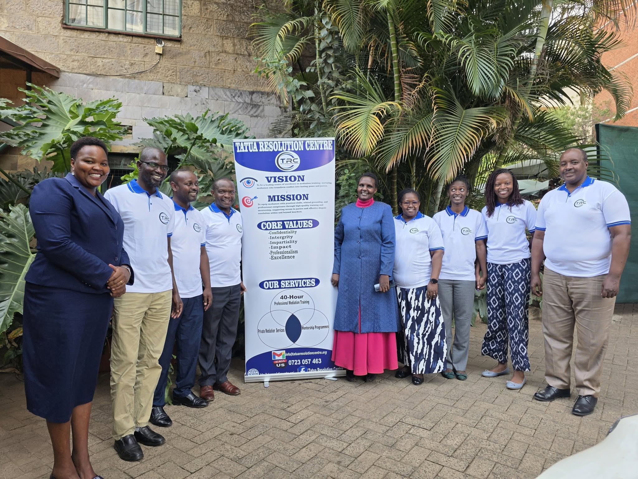 People pictured with the Tatua Resolution Centre banner